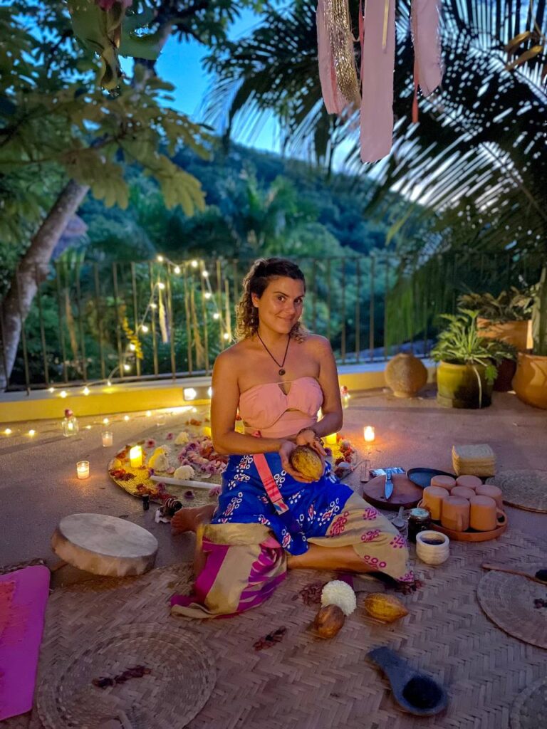 Sol Luciana holding cacao at a ceremony