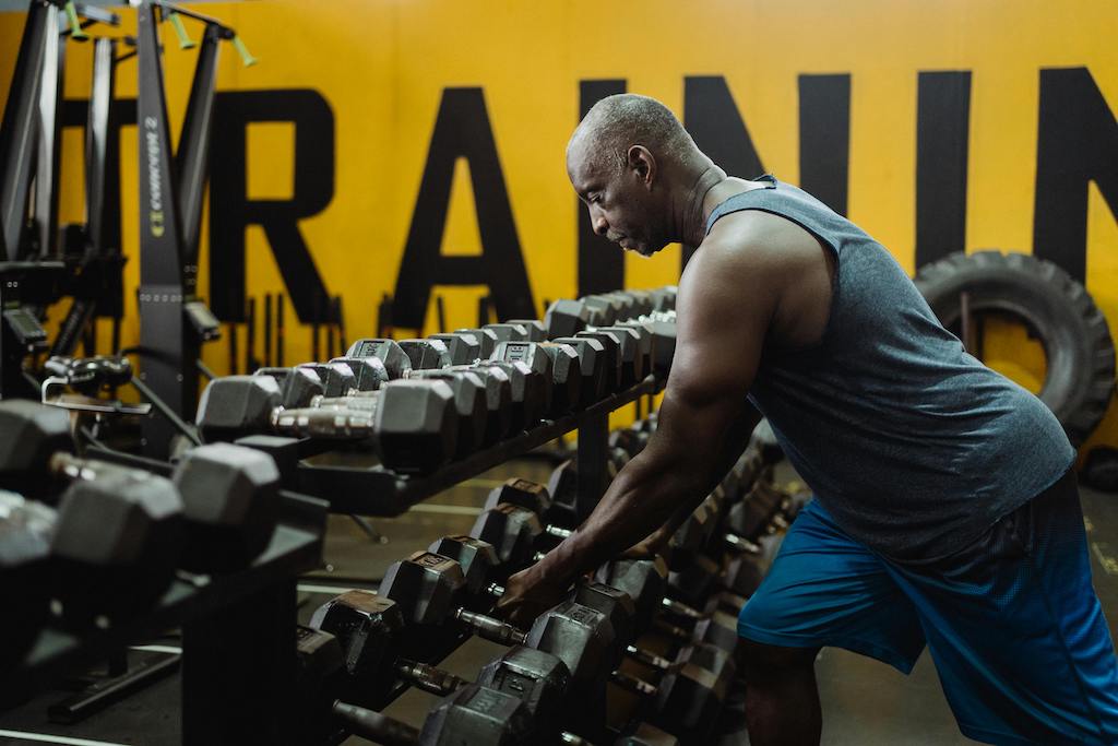 Man lifting weights during evening strength workout