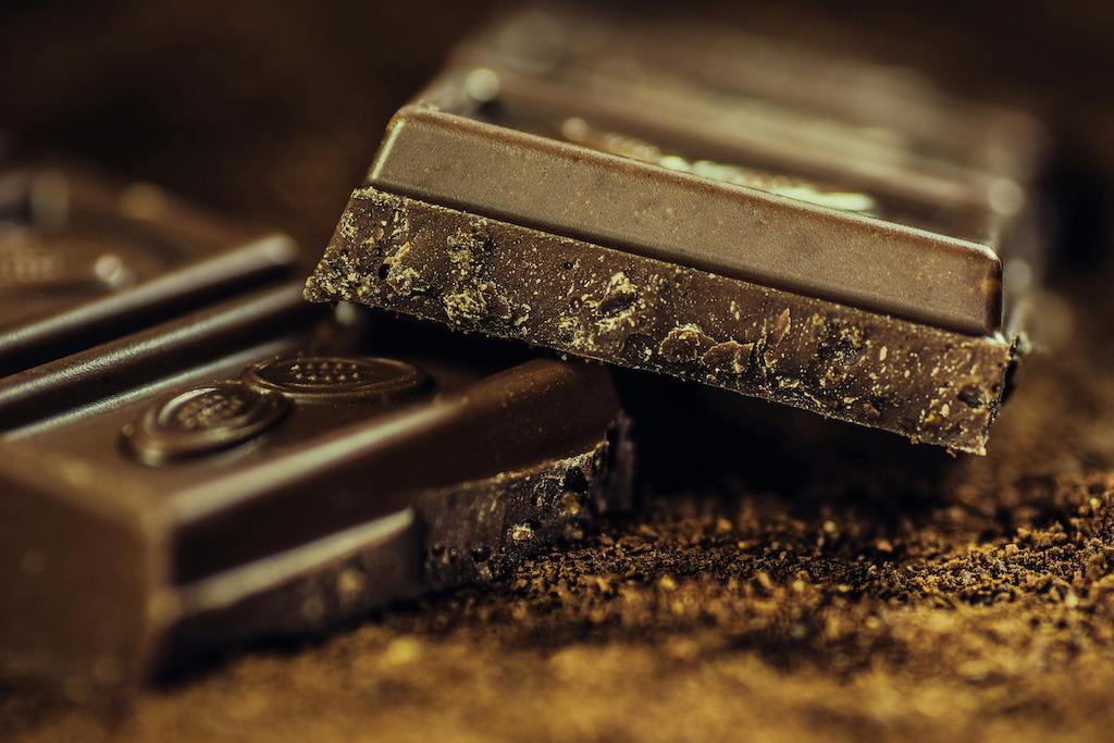 Dark chocolate contains compounds like flavonoids, caffeine, and theobromine, all of which may enhance mood and brain function.