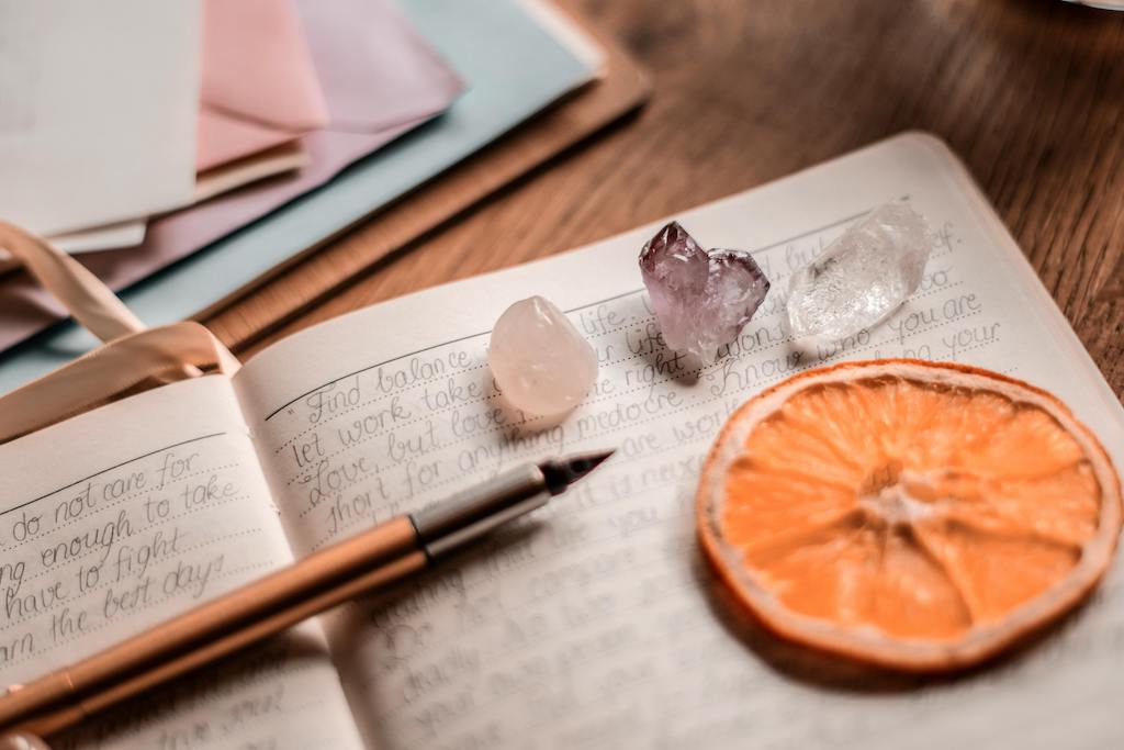 Open journal with crystals and moonlight pouring in through a window