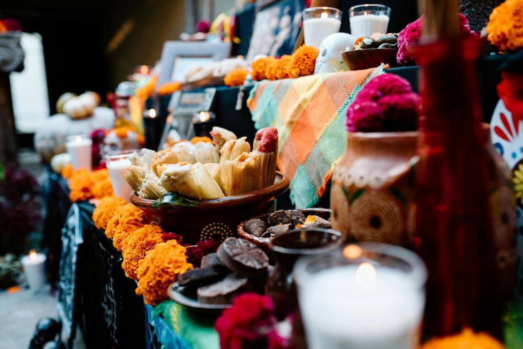Dia De Los Muertos altars are not just for decorations but invitations through food, drink and photos placed with careful thought.