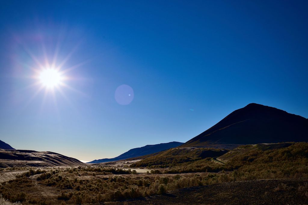 Bright sunshine high in the sky over a beautiful mountain landscape. Summer solstice is here