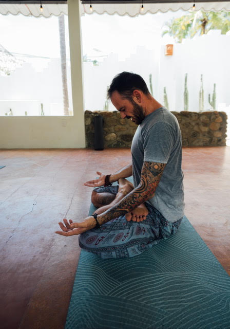 Jonathane sitting in quiet meditation pose